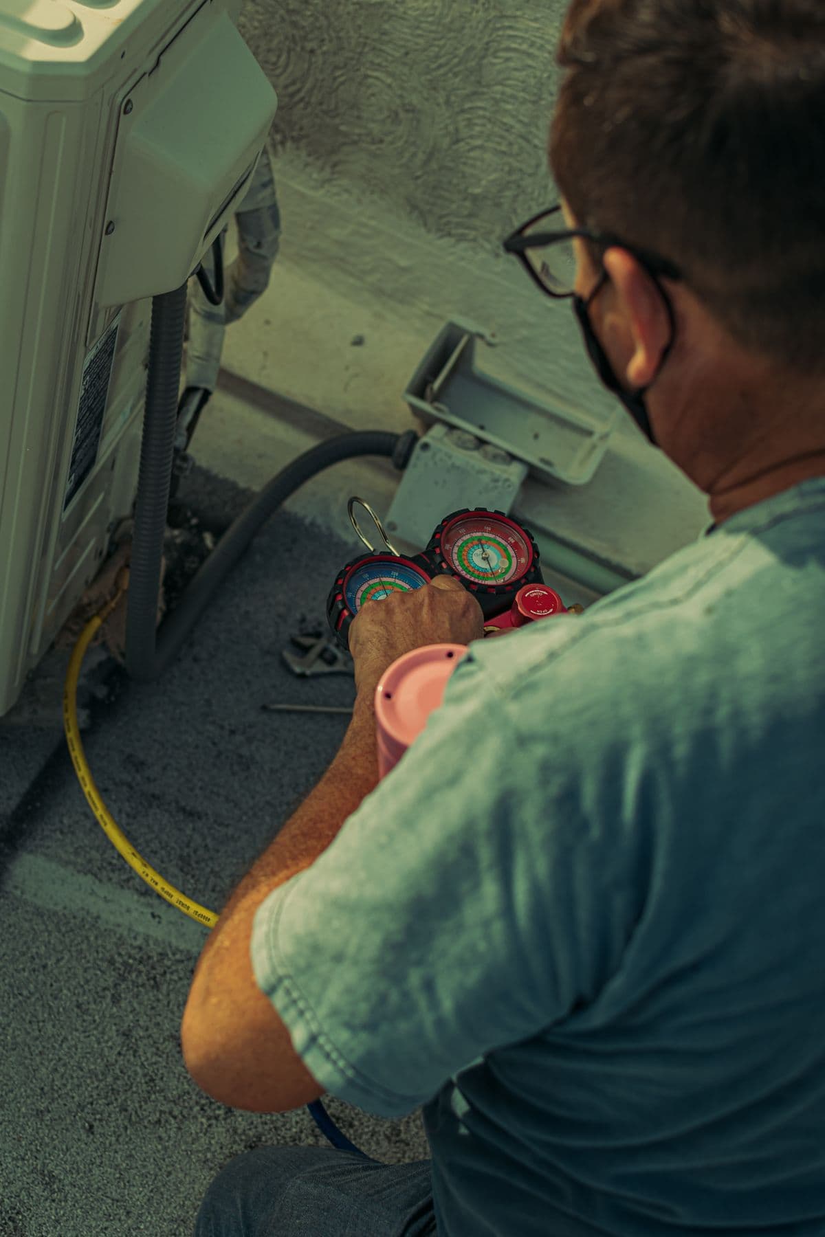 A field service technician checking an outdoor system
